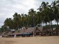 Palapa restaurants line the beach